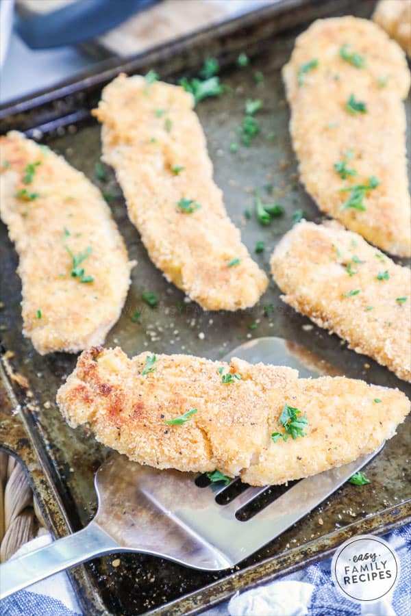 Spatula lifts a healthy piece of grilled chicken