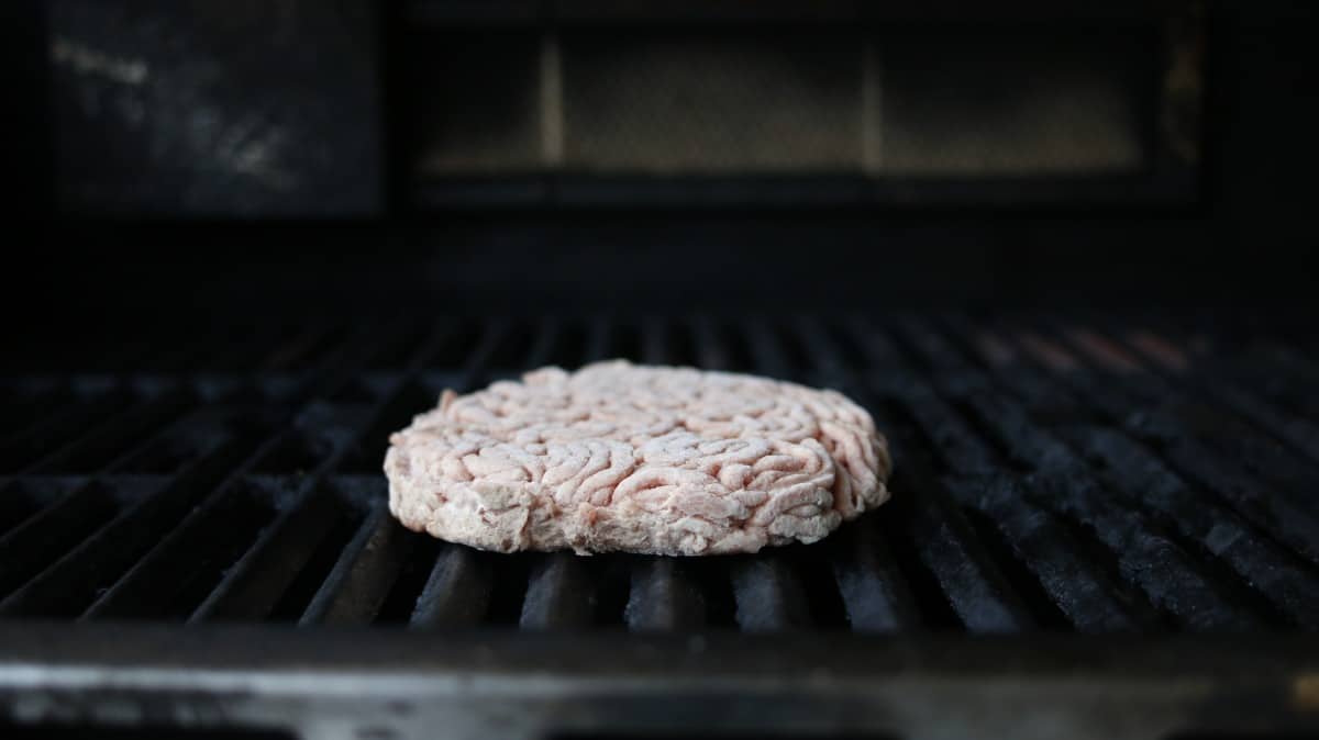 Close-up of a frozen burger on several grills