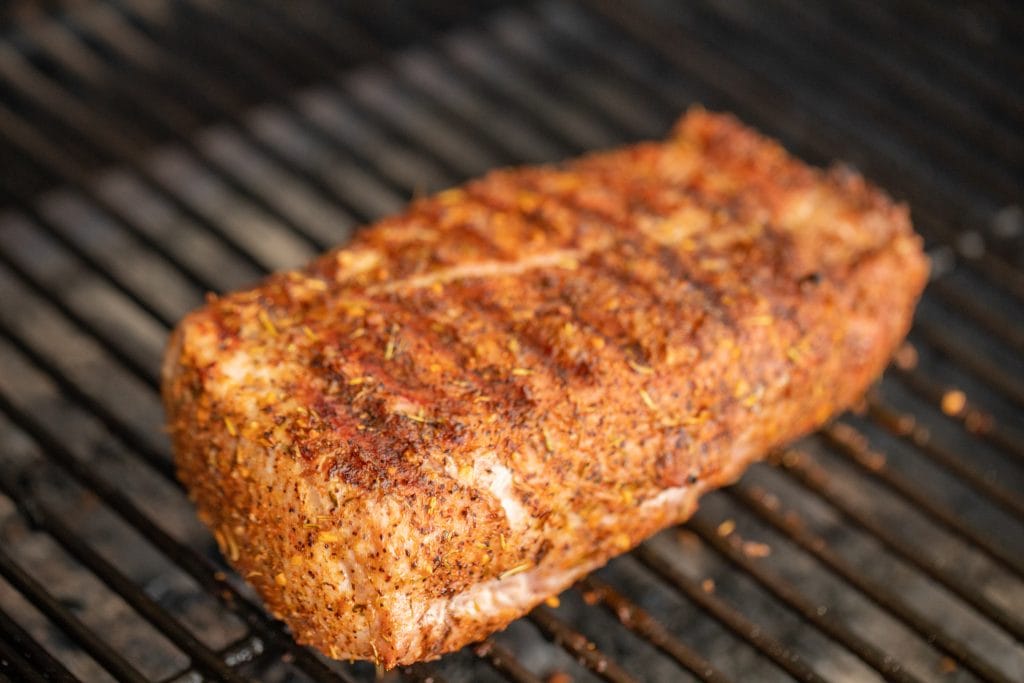 Pork tenderloin grilled on a charcoal grill.