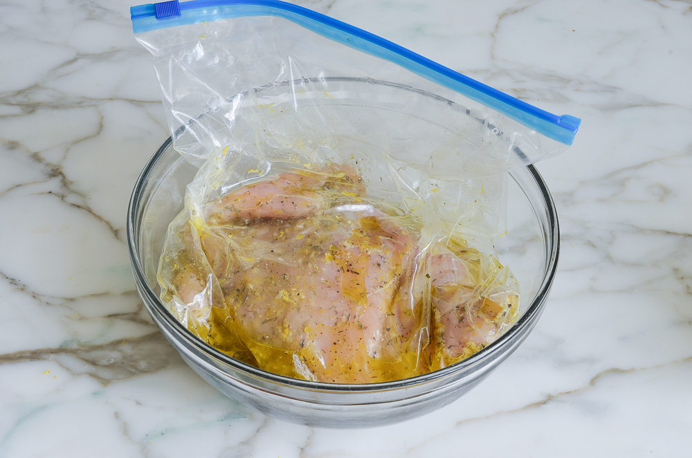 sealed chicken in a bowl ready to marinate in the fridge