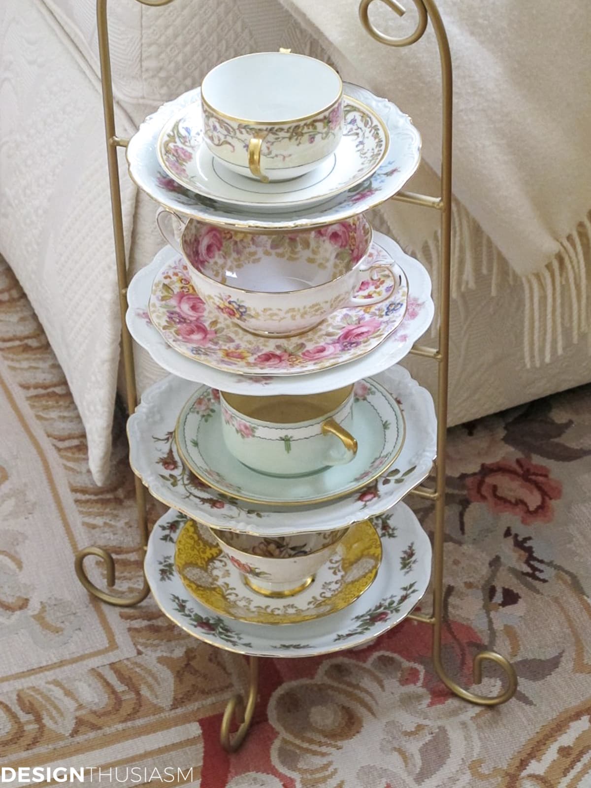 vintage tea cups and plates displayed on a wire shelf