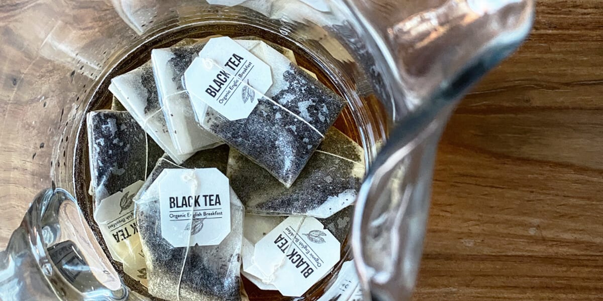 Black tea bags at the bottom of the glass vase