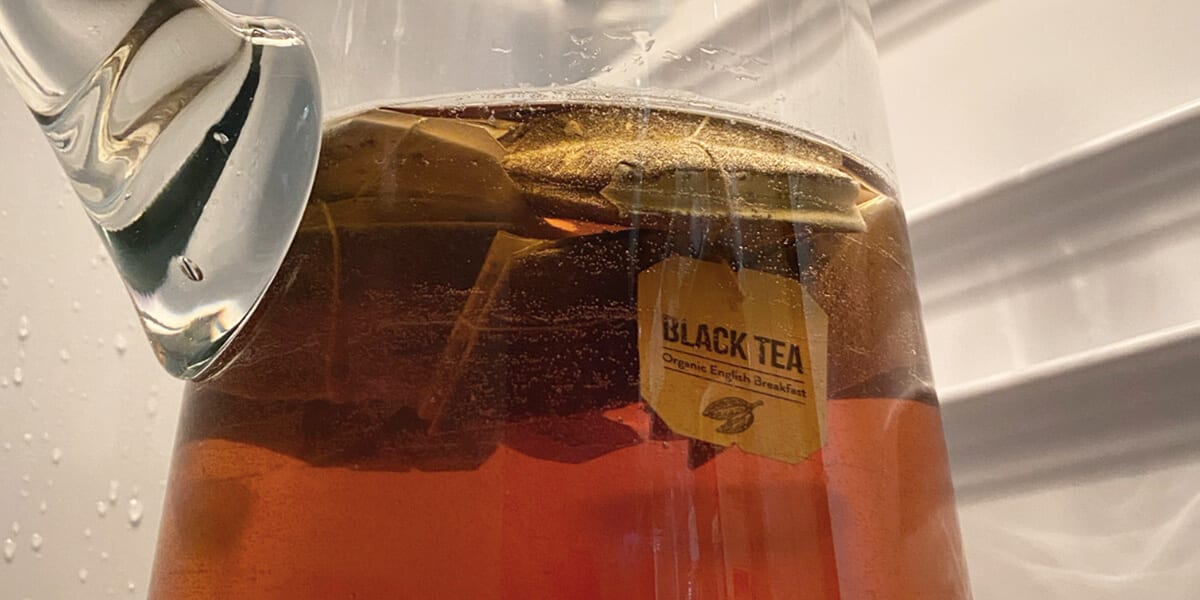 Black tea steeped in a glass vase