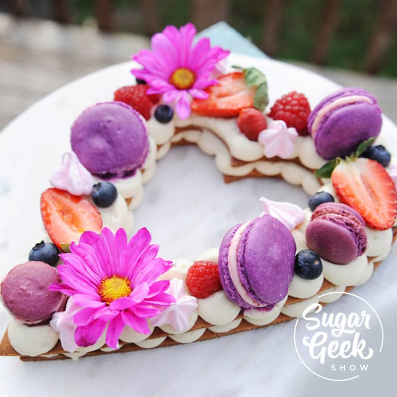 Cream Tart cake decorated with fresh flowers and covered with chocolate