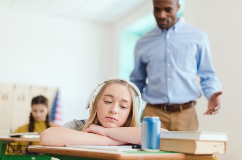 A 13-year-old girl has encountered a red bull before and felt rushed, but now she is feeling the impact as she is sitting in her classroom at school.