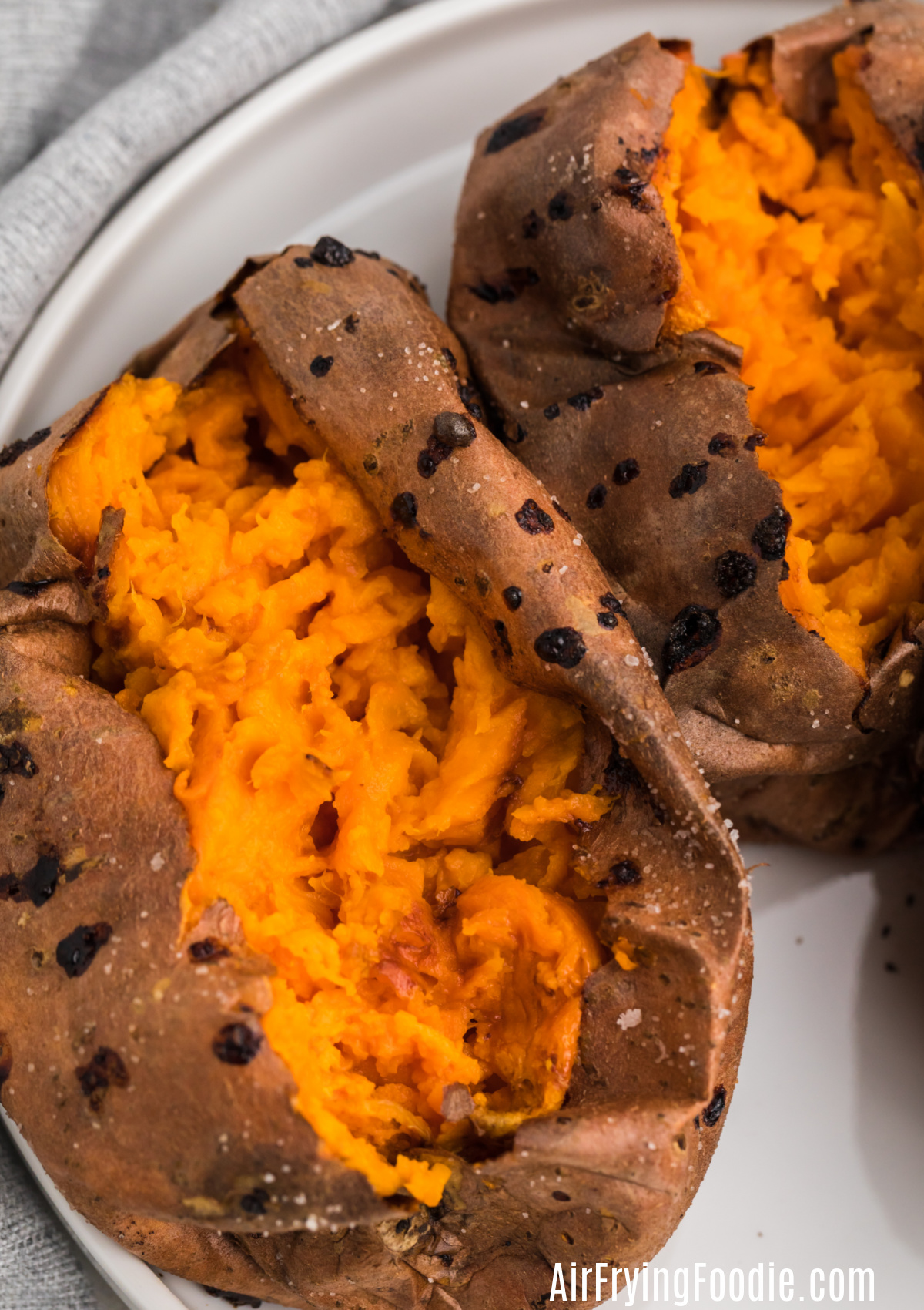 Close-up shot of baked sweet potatoes made in an air fryer - pre-sliced ​​and ready to be topped.