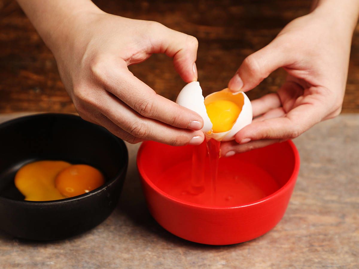 Separating eggs in red bowl