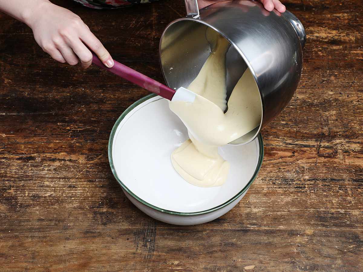 Pouring beaten egg yolks into white bowl