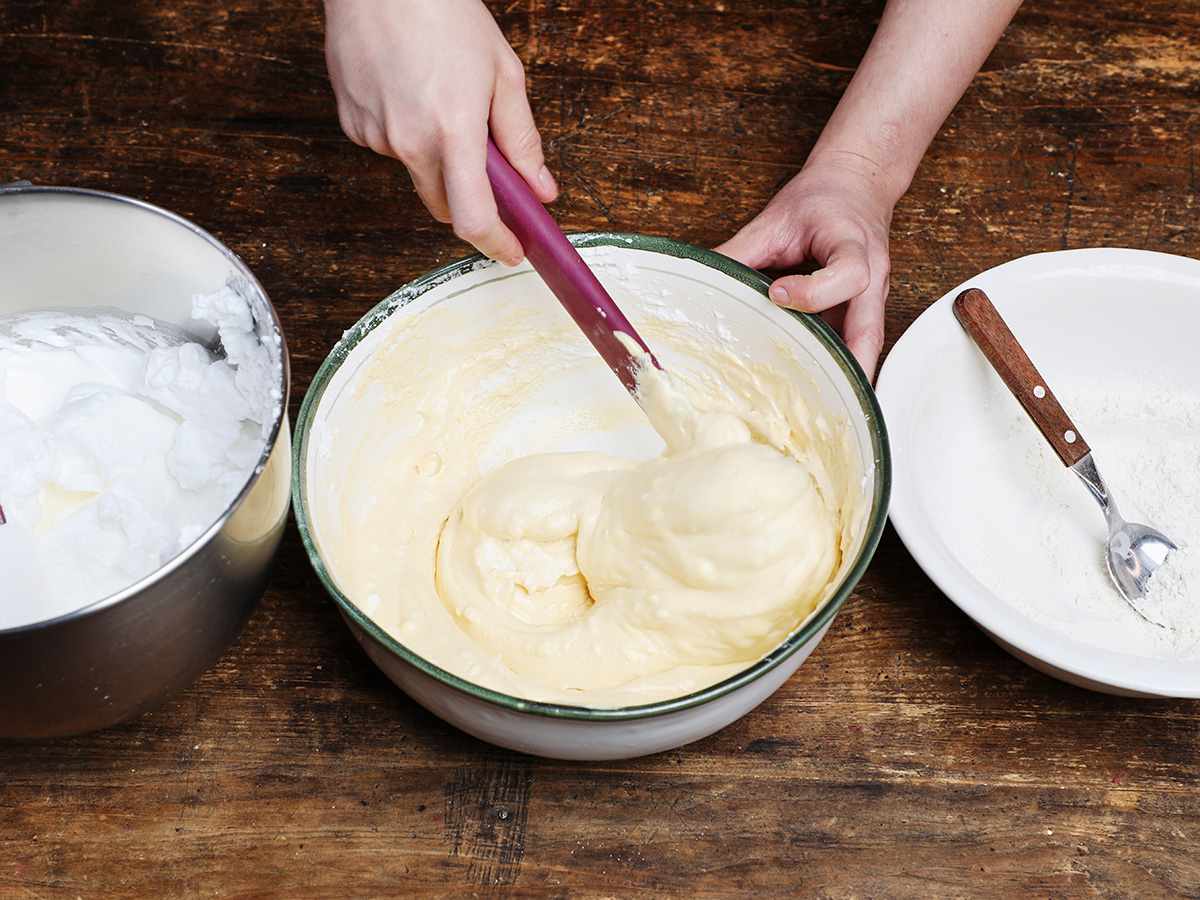 Stirring tres leches cake batter with spatula