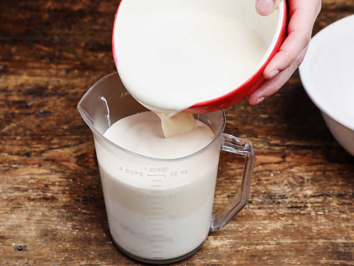 Pouring evaporated milk into measuring cup