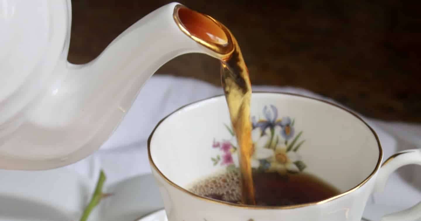 pour a cup of tea into a beautiful porcelain mug