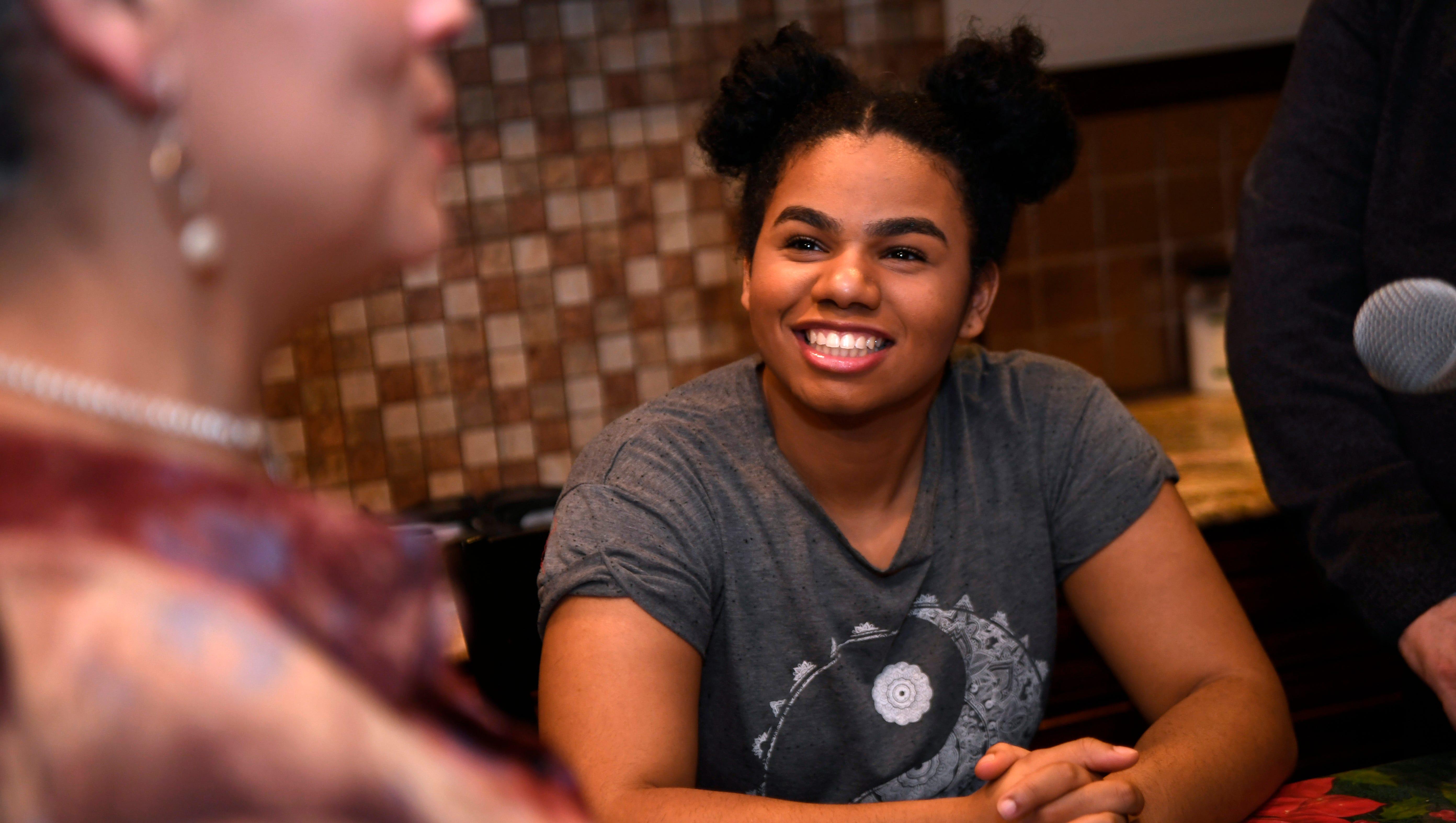 Wé McDonald talks to her mother, Jacqueline, in the kitchen of their Paterson house.