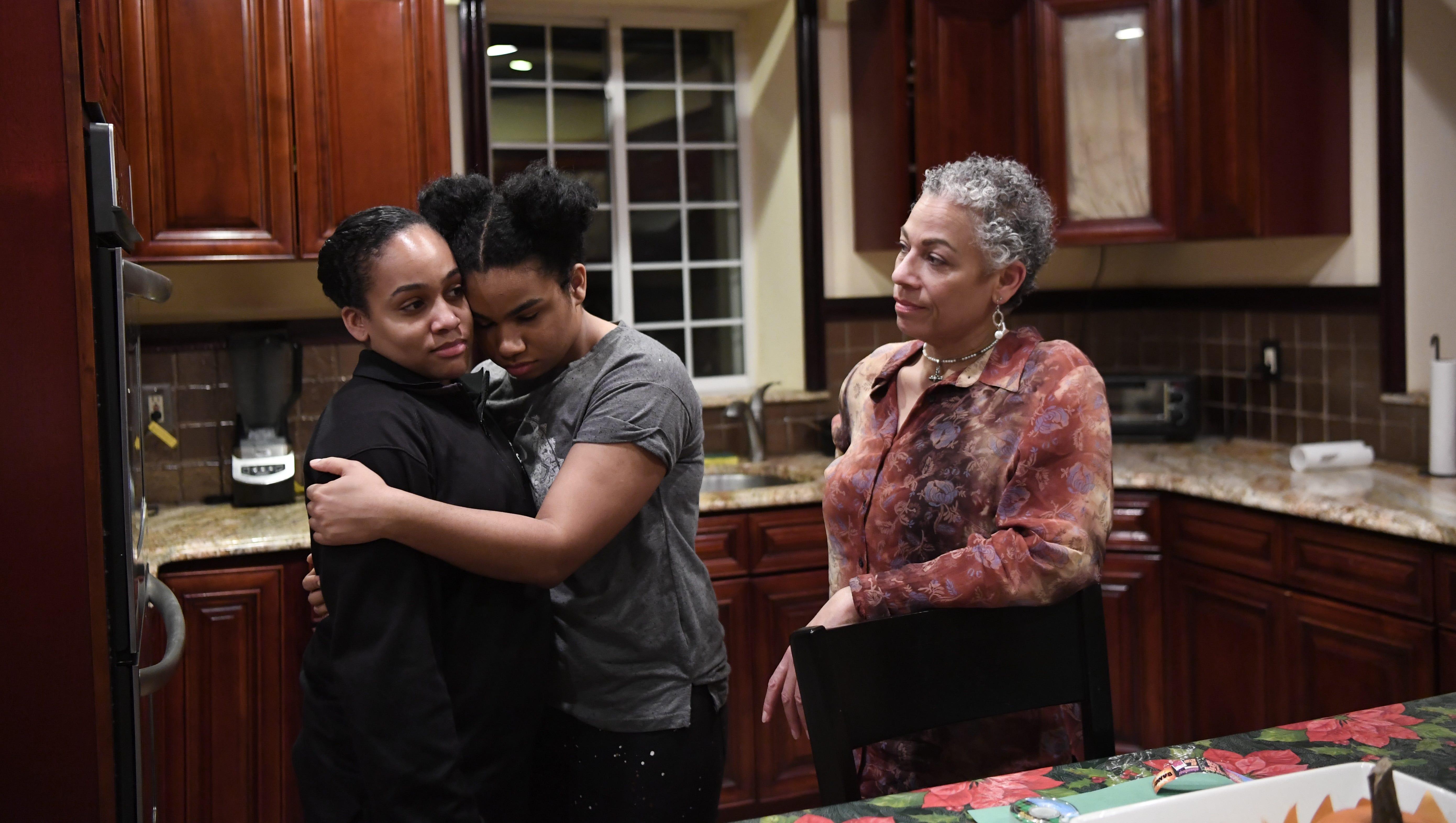 Wé McDonald, center, is at home with her sister, Jasmine, and mother, Jaqueline.