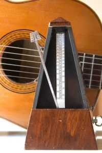 acoustic guitar with old metronome