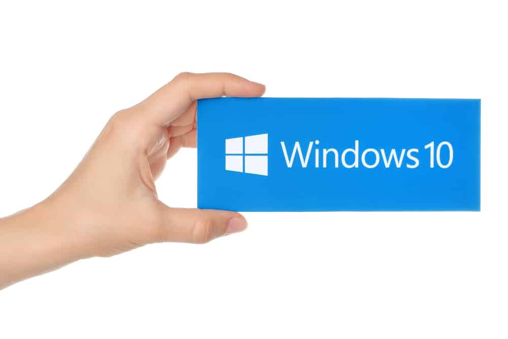 Hand holds Windows 10 logotype printed on paper