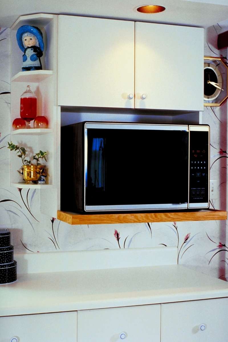 A great option for those wondering where to put a microwave in a small kitchen is to use a microwave oven rack under a tall cabinet.