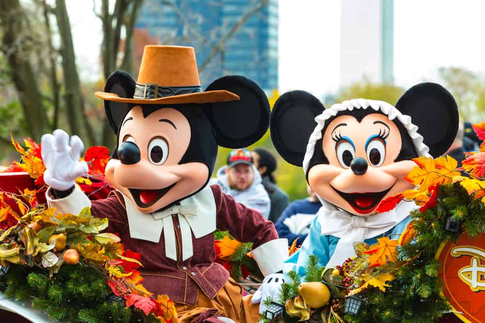 Mickey and Minnie Mouse ride in a carriage