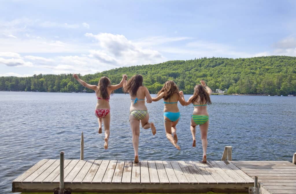 bigstock Four Girls Jumping Off A Dock 5405597
