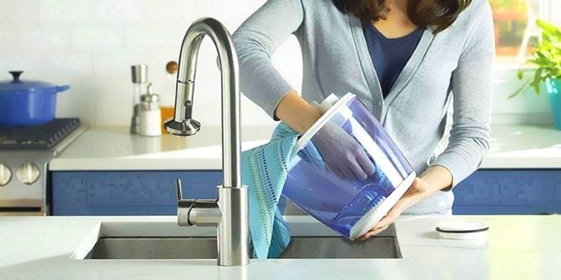 Image of a woman cleaning a humidifier water tank