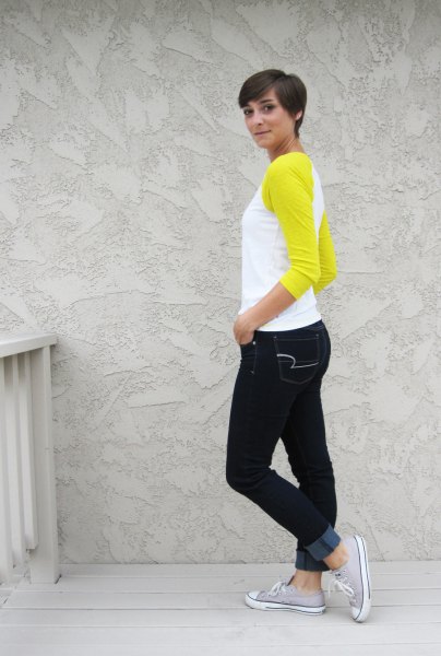 yellow and white baseball t-shirt and black skinny jeans