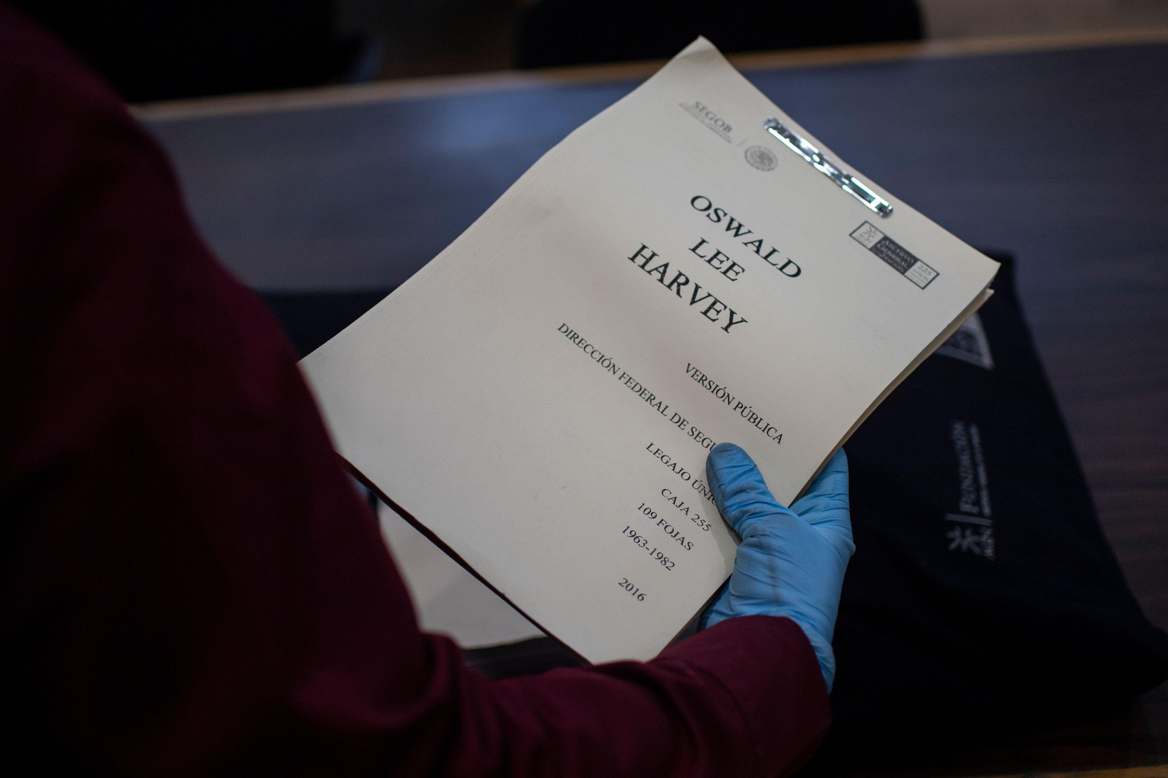 Glove hand holding a paper report titled