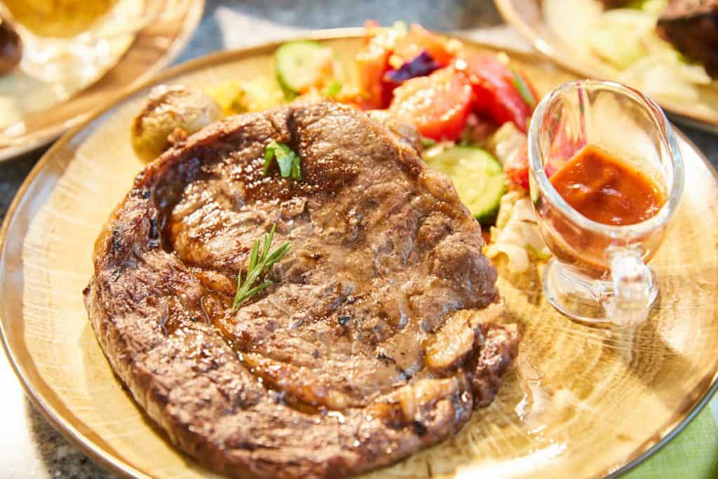 large piece of grilled meat and vegetables