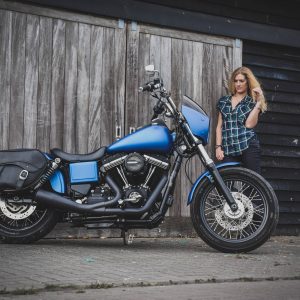 Vinyl wraps a matte metallic blue Harley-Davidson motorcycle
