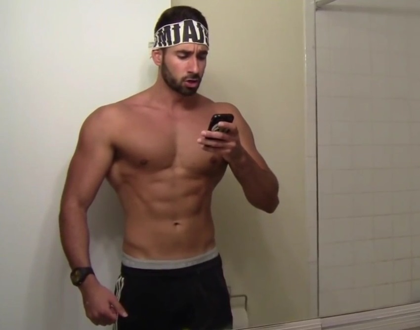 Dom Mazzetti takes a picture of himself in the mirror, revealing his abs, chest and arms