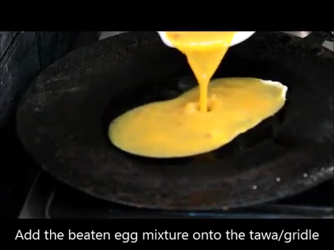 egg mixture poured over heated tawa