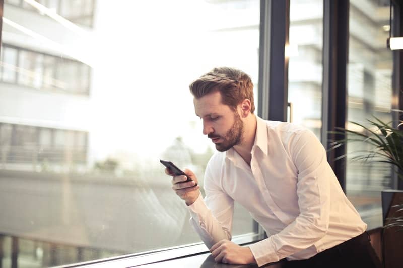 man typing on his phone