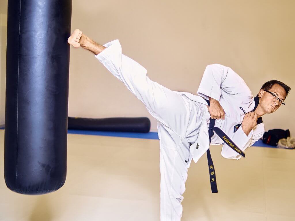 Taekwondo kicks on heavy sacks.
