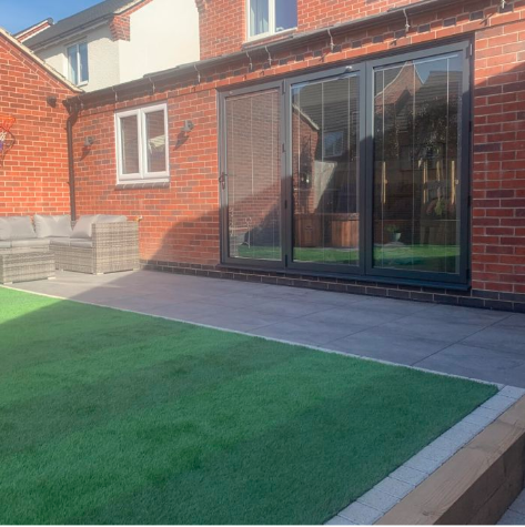 A gray stone concrete effect patio with outdoor porcelain tiles