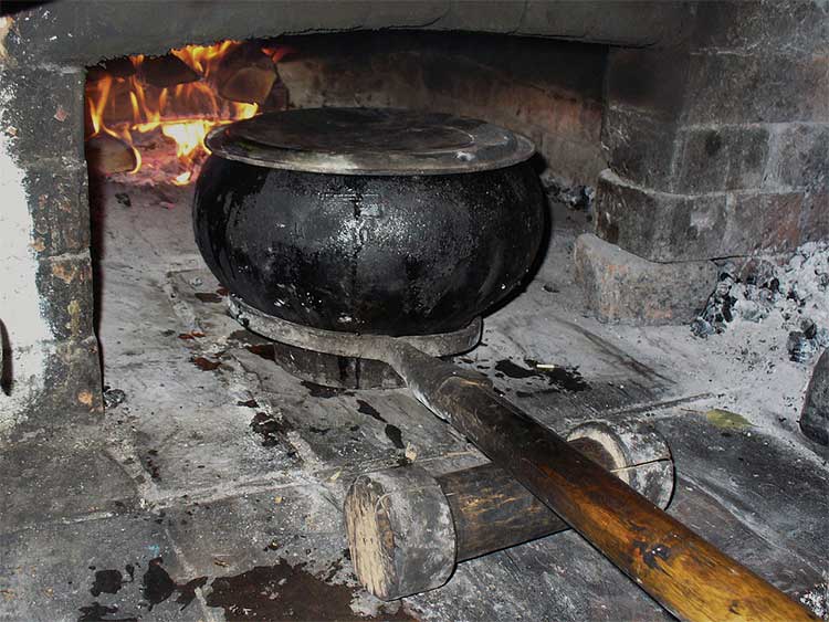 A traditional chugukok and long-handled tool are used to remove it from the hearth. An example of another culture