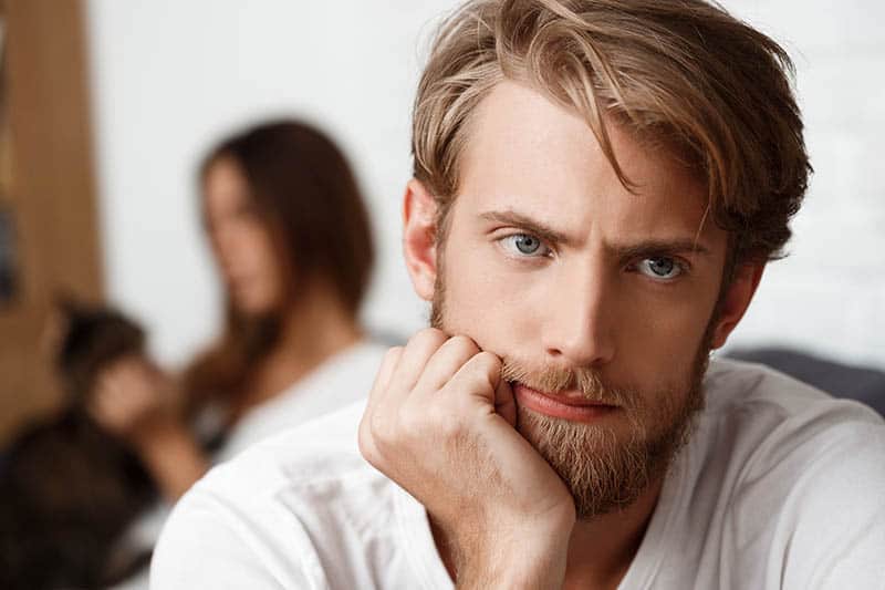 shallow concentration of attentive man sitting next to woman at home