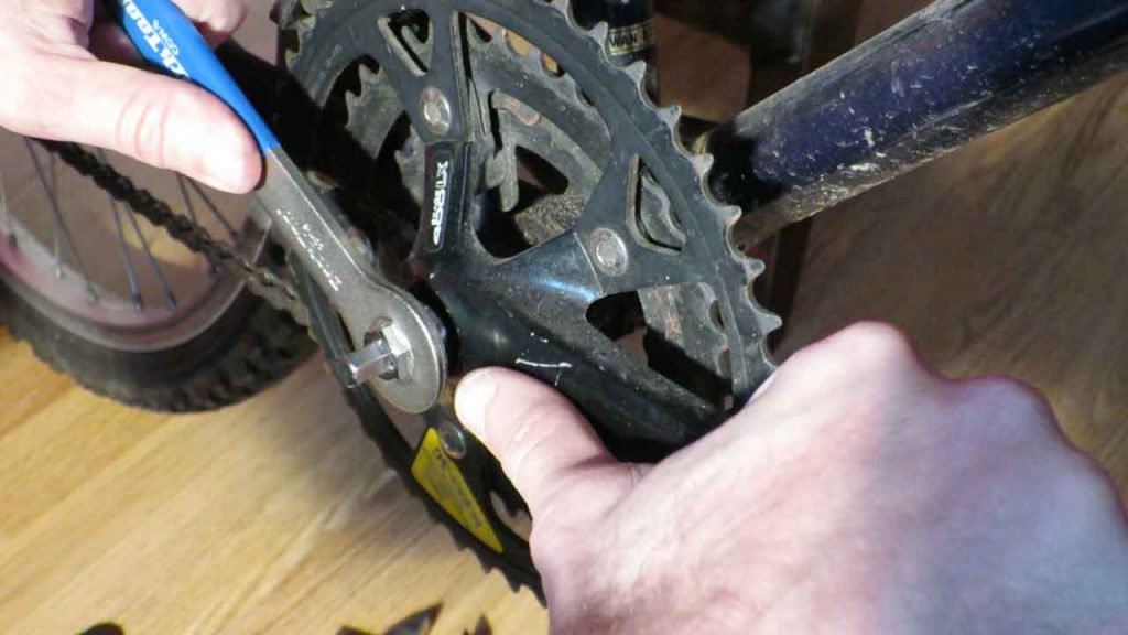 unscrew the crank bolt