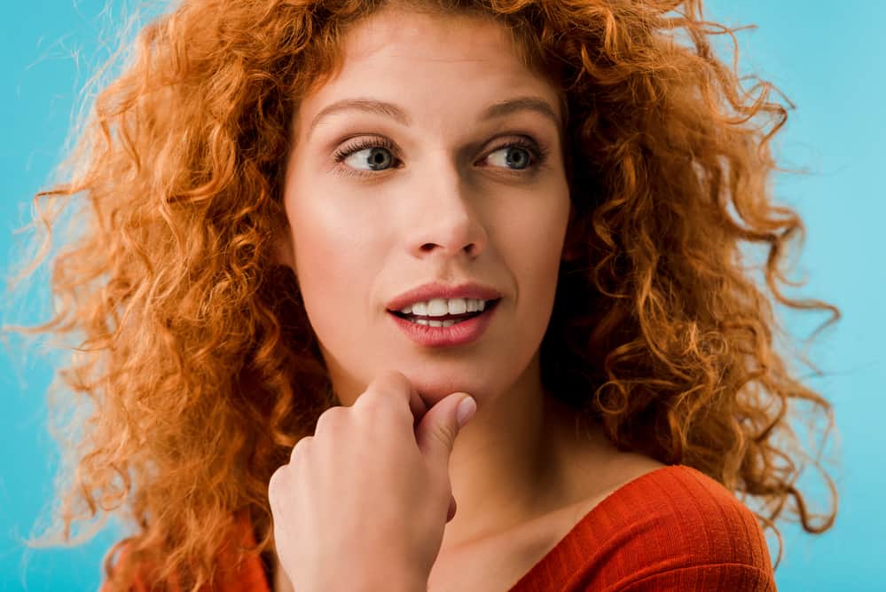 Adult Caucasian women with the mc1r gene with naturally red hair and light skin wear red shirts.