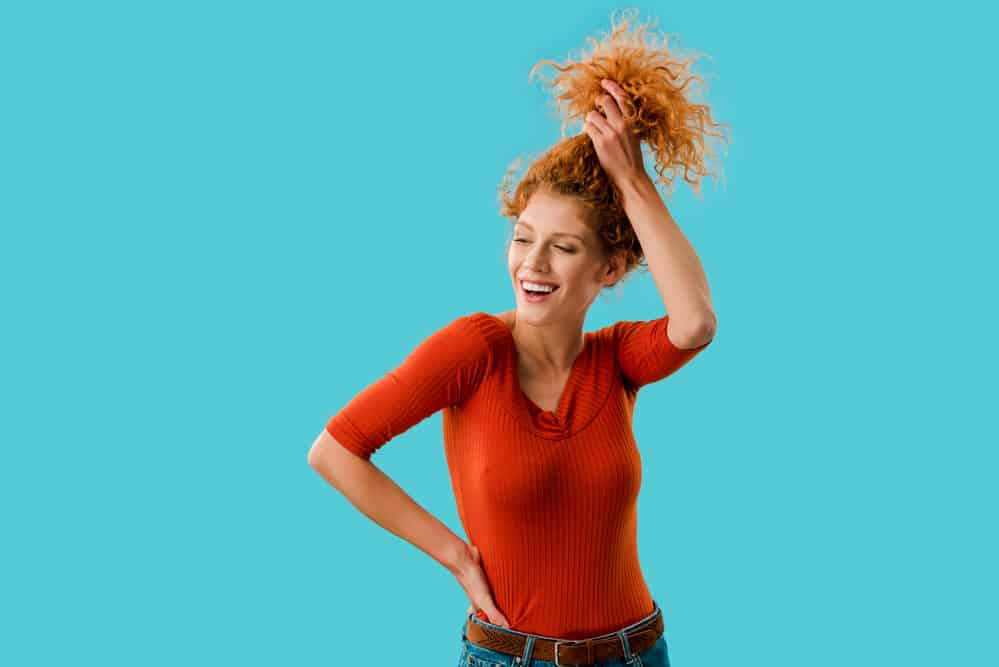 European American women with pineapple hairstyle on wavy curls.