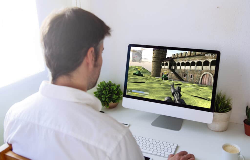 man playing war video game on computer