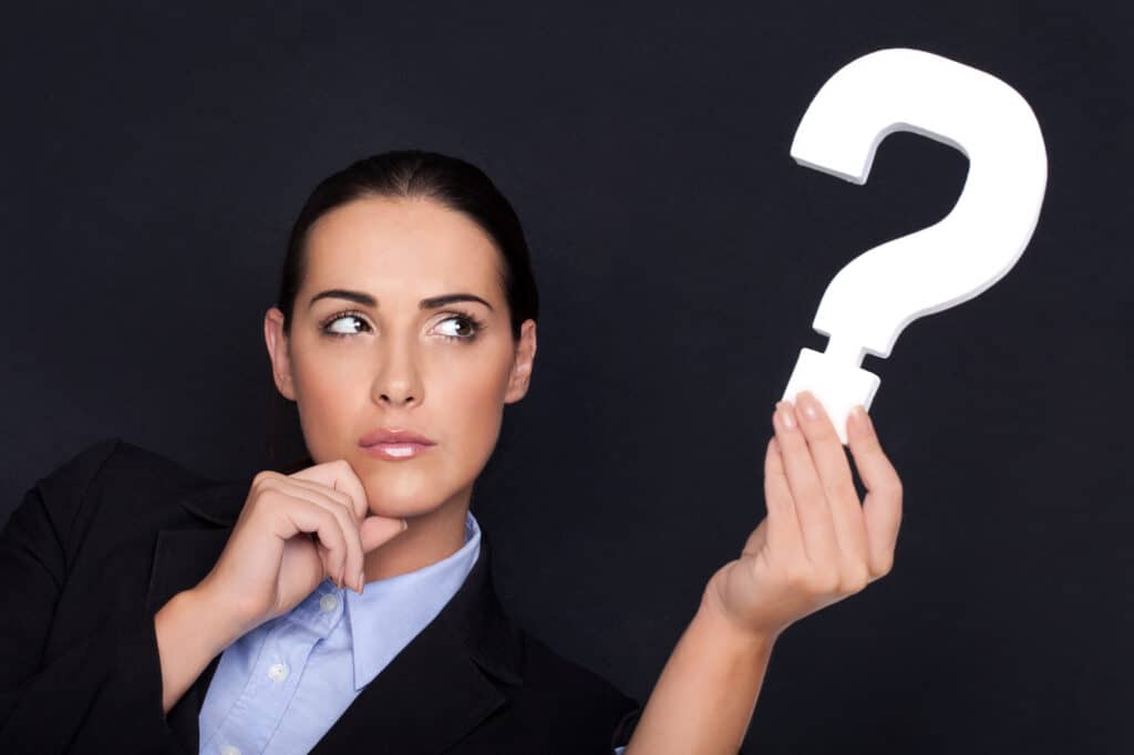 Businesswoman holding question mark