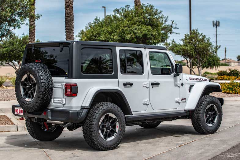 Park a white Jeep Wrangler Rubicon