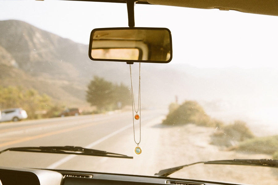 christopher necklace hanging on the rearview mirror