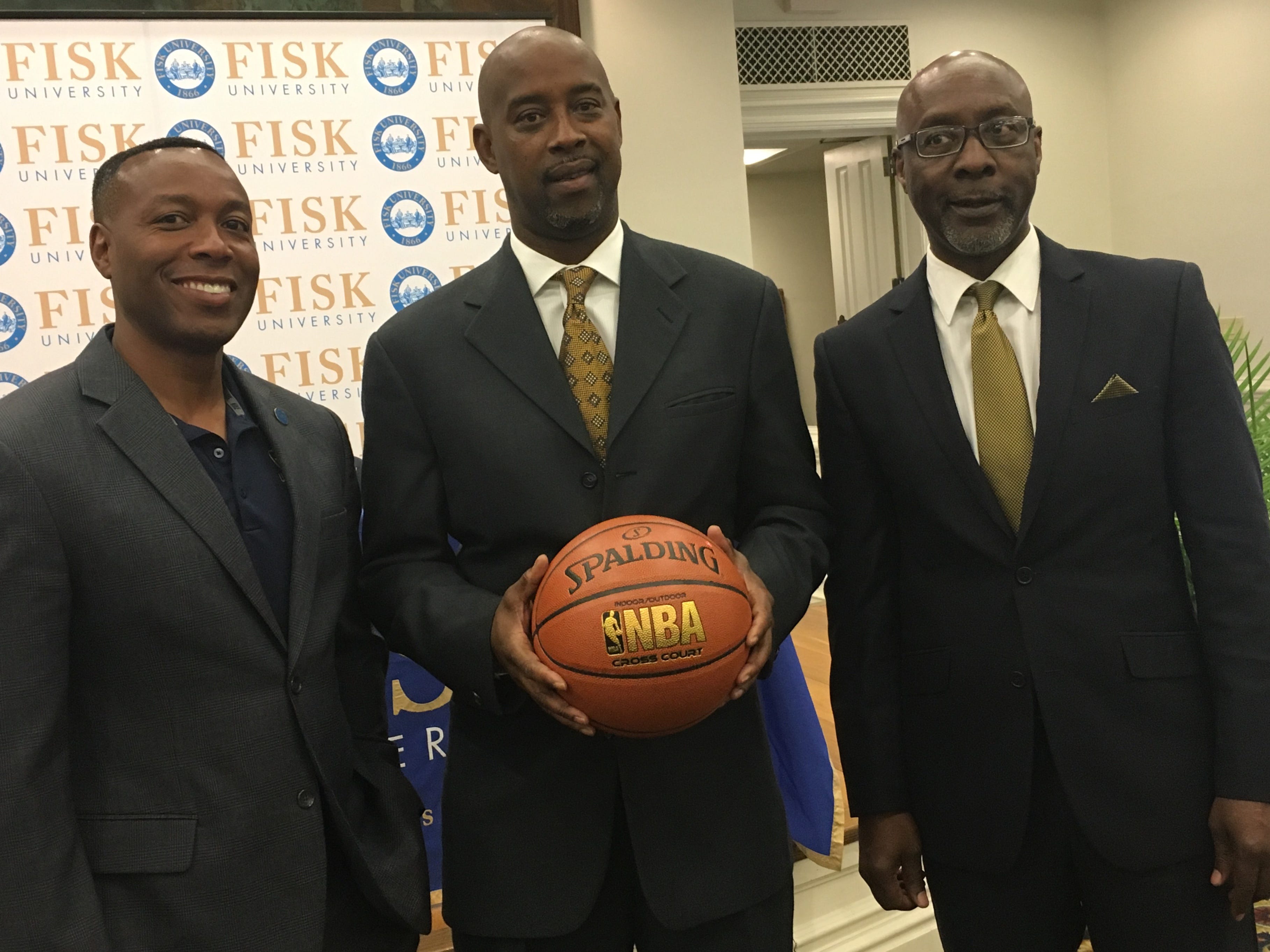Kenny Anderson, center, with Fisk University President Kevin Rome, left, and athletic director Larry Glover.