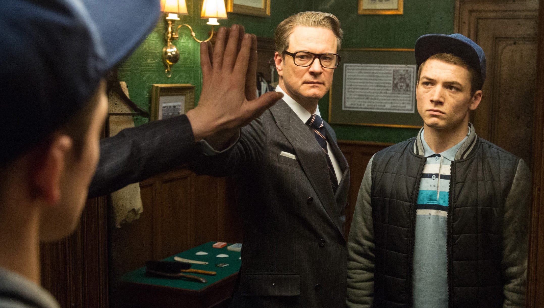 Harry (Colin Firth) helps Eggsy (Taron Egerton) in the spy business in