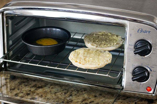 A small pan and English muffin inside the toaster.
