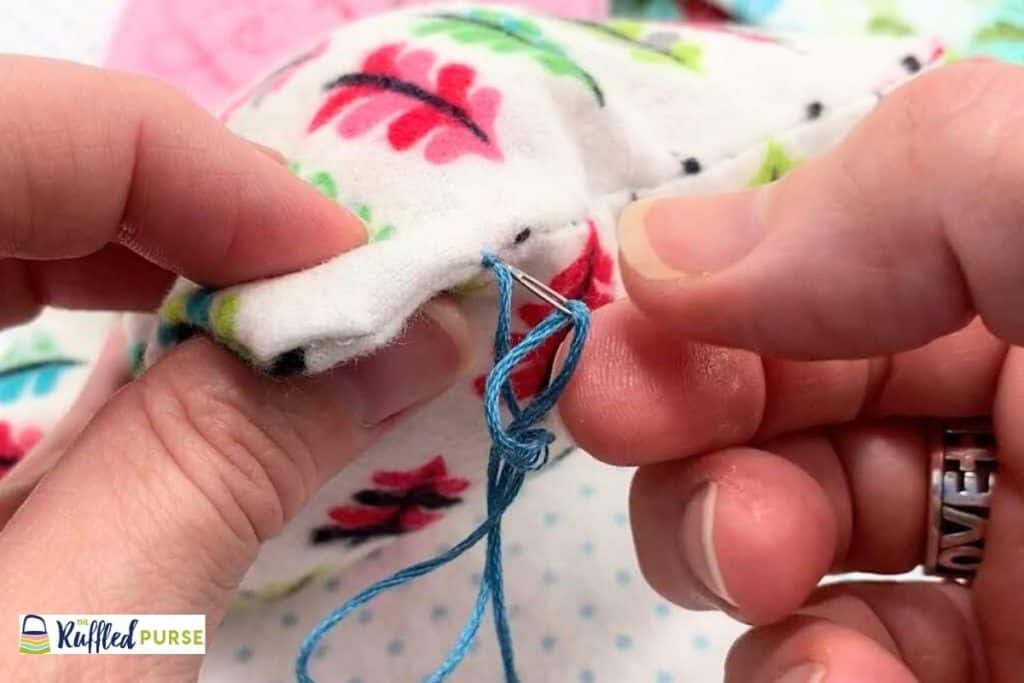 Push needle in seam by the knot.