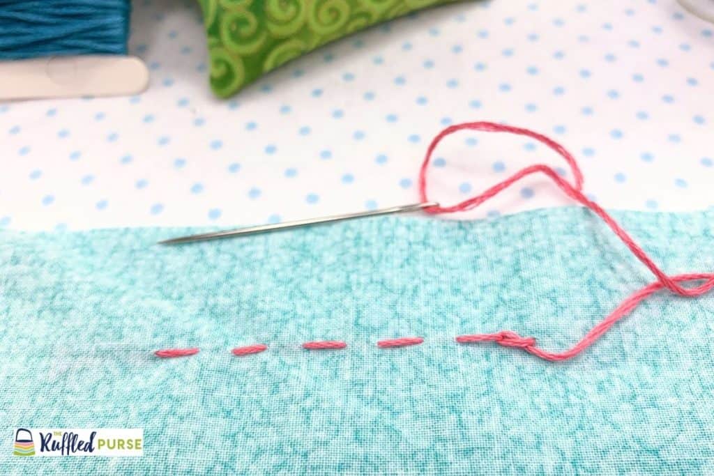 Pull thread to make a knot.