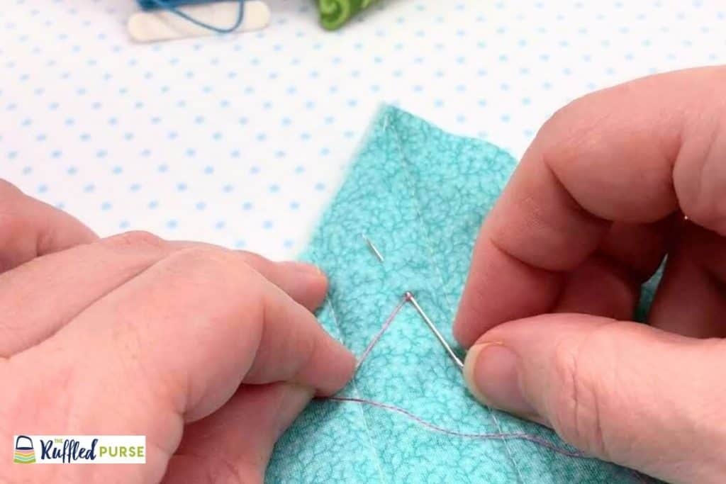 Bring needle back to the top of the fabric.