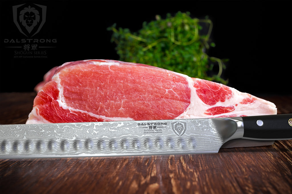 Carving knife on a wooden table in front of uncooked red meat