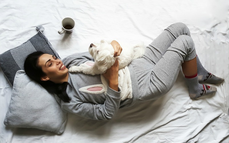 Woman and dog in bed