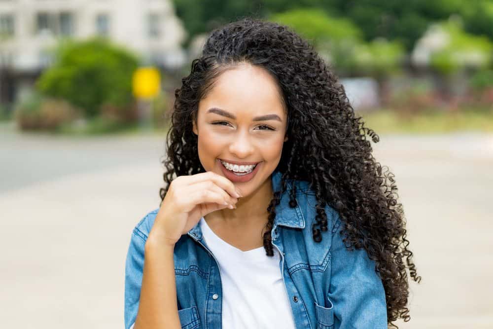 African American female with naturally curly type 3c hair.